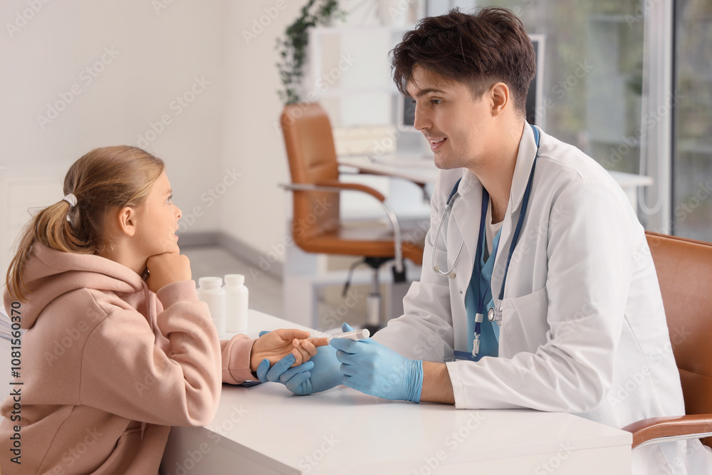 Diabetic girl with doctor using lancet pen at table in clinic Diabetic girl with doctor using lancet pen at table in clinic