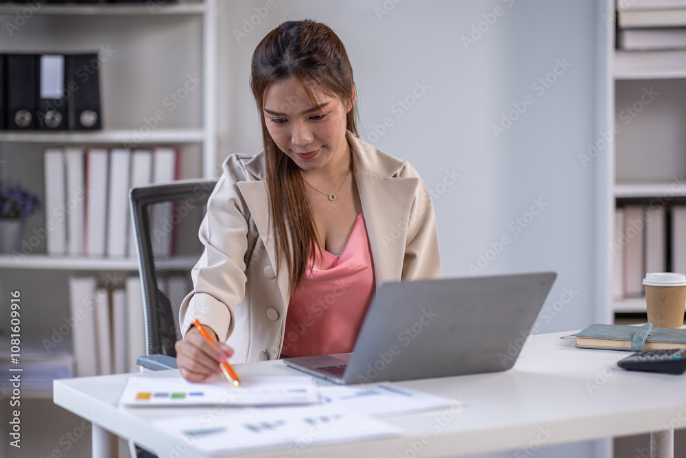 Asian business woman using calculator and laptop for doing math finance on an office desk, tax, report, accounting, statistics, and analytical research concept Asian business woman using calculator and laptop for doing math finance on an office desk, tax, report, accounting, statistics, and analytical research concept