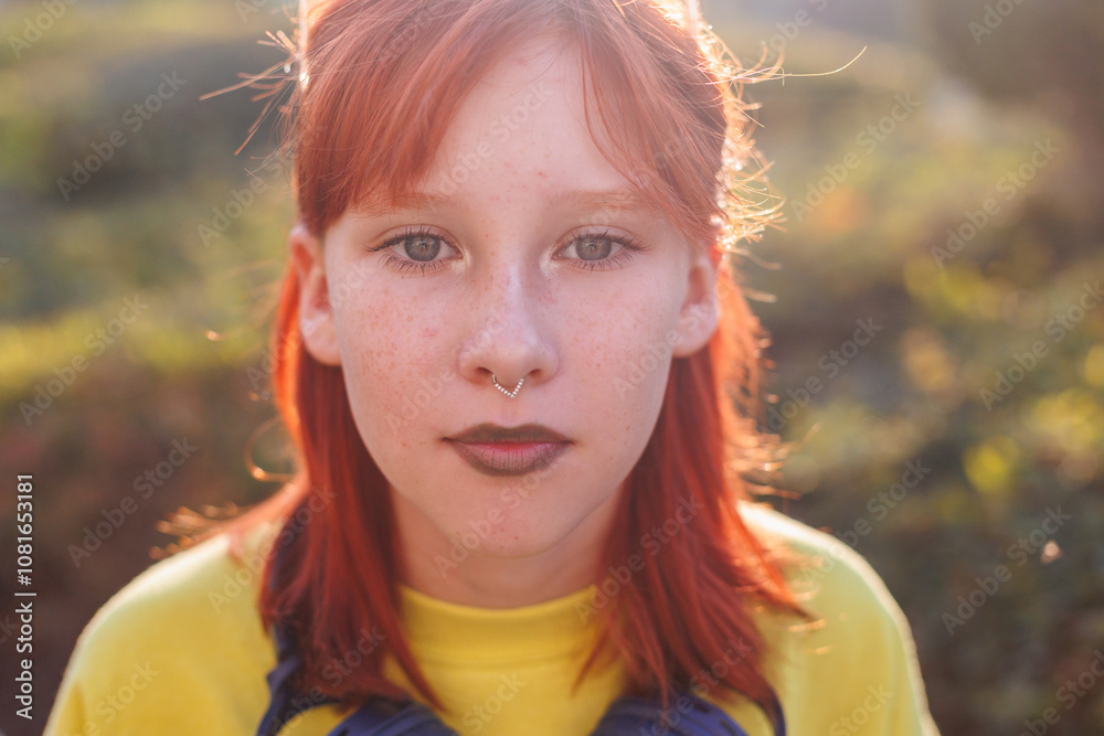 Young beautiful smiling girl with piercing on her face in fashionable clothes. Carefree woman smiling on the street on a sunny day. Young beautiful smiling girl with piercing on her face in fashionable clothes. Carefree woman smiling on the street on a sunny day.