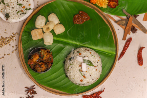 Coconut Rice is a popular South Indian food on banana leaf photo