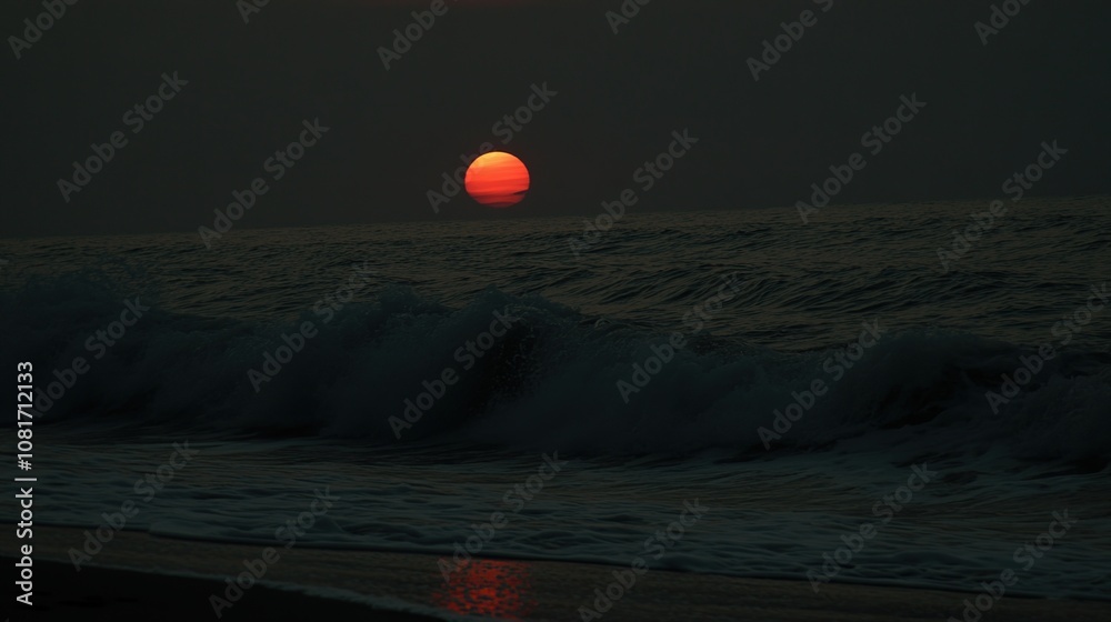A fiery sunset over the ocean, with waves crashing on the shore. A fiery sunset over the ocean, with waves crashing on the shore.