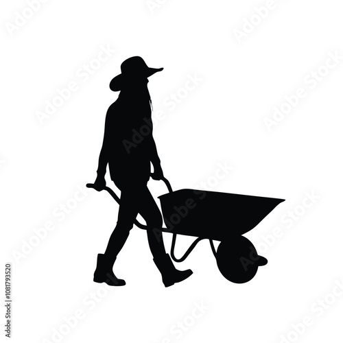 A woman is walking with a wheelbarrow. She is wearing a hat and a shirt. The wheelbarrow is full of dirt
