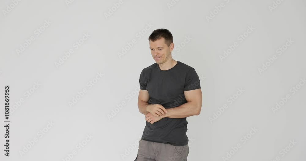 Man with crossed arms and emotions of embarrassment Man with crossed arms and emotions of embarrassment