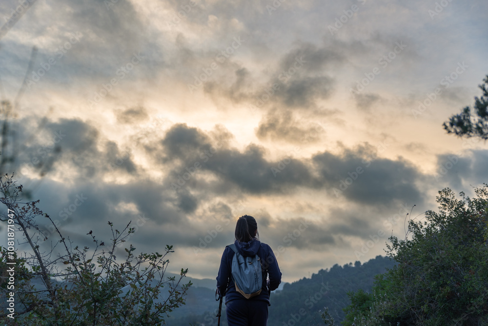 Hiker contemplates the immensity of nature during his mountain excursion. Hiker contemplates the immensity of nature during his mountain excursion.