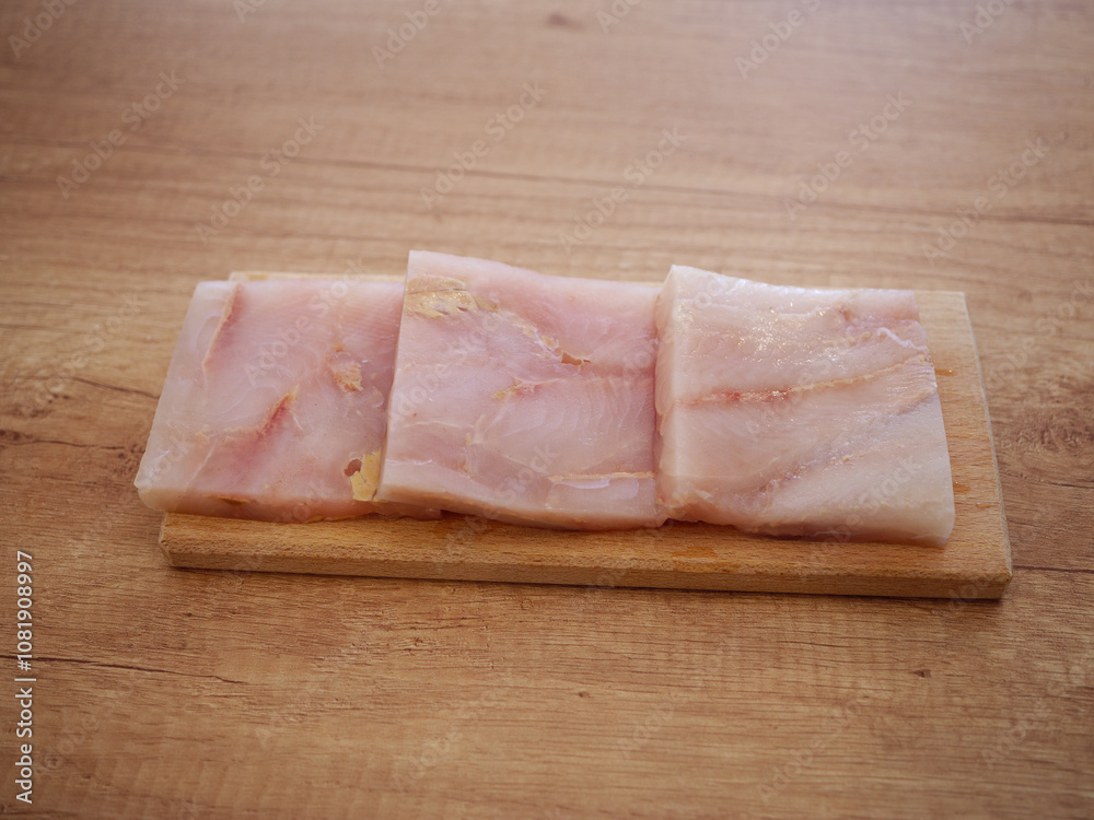 Cod fillets in the kitchen ready for processing. Fish is a very healthy and low-calorie food. They contain a lot of protein and healthy fats. Cod fillets in the kitchen ready for processing. Fish is a very healthy and low-calorie food. They contain a lot of protein and healthy fats.