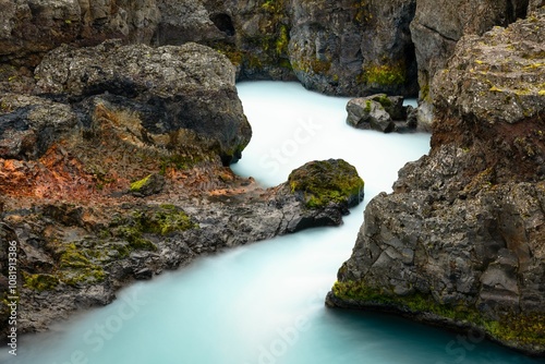 Serene river through rugged rocks