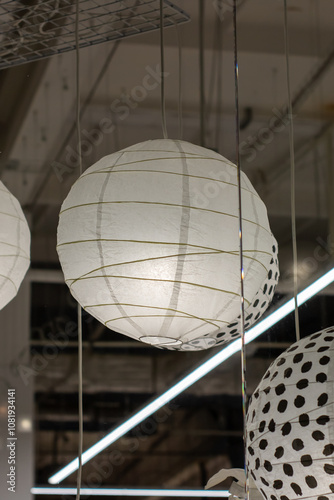 White polka dot lanterns gracefully hang from the ceiling