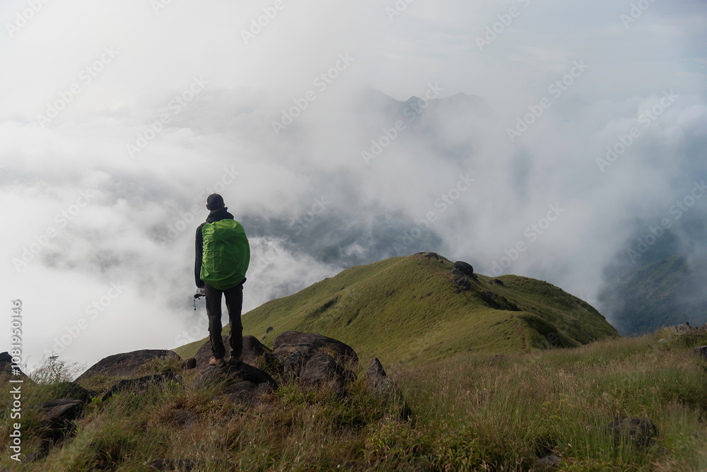 Traveler sightseeing the beautiful scenery of nature and mist during time the sunrise Traveler sightseeing the beautiful scenery of nature and mist during time the sunrise
