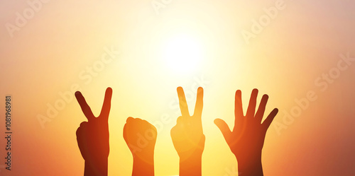 Happy new year 2025. Silhouette of four hands with 2025 symbol at fantastic sunrise or sunset sky background. 2025 concept banner with copy space.