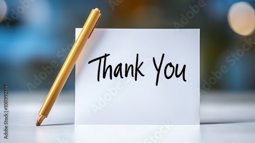 Handwritten Thank You Note with Pen on White Table