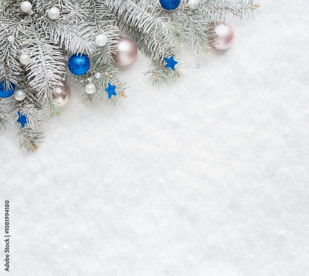 Christmas tree branches with decorations on the background of natural snow with empty space for text. Flat lay. Christmas and New Year background