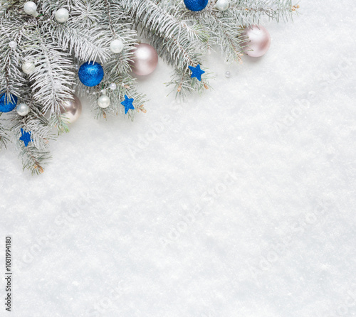  Christmas tree branches with  decorations on the background of natural snow with empty space for text.  Flat lay.  Christmas and New Year background