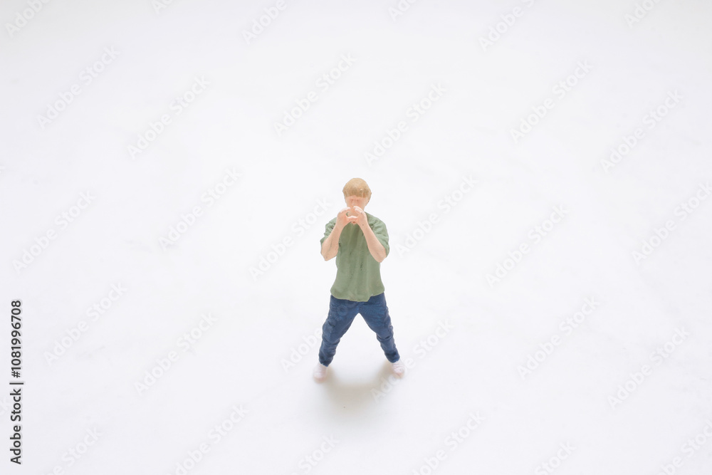 Miniature Figure of Man Standing on White Background Miniature Figure of Man Standing on White Background