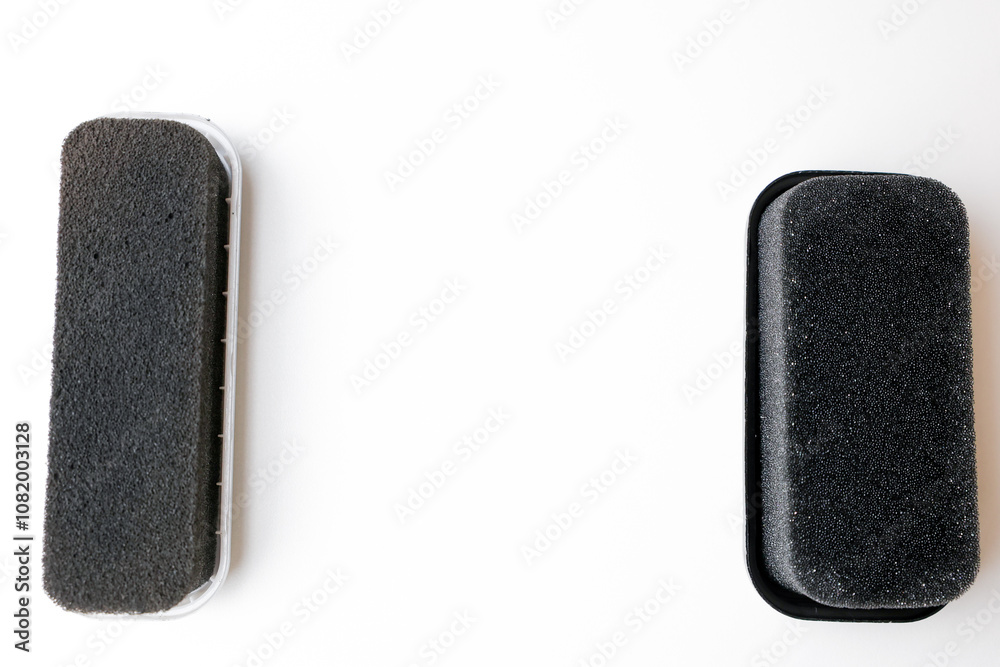 Sponges for black leather shoes lie on a white background with space for text. High quality photo Sponges for black leather shoes lie on a white background with space for text. High quality photo