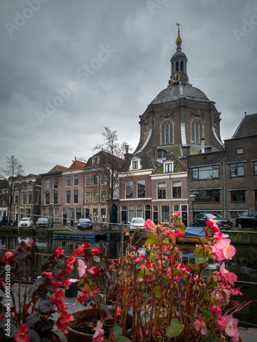 Leiden, Netherlands 10 November 2024, The Oude Vest canal, traditional houses and Marekerk Protestant church