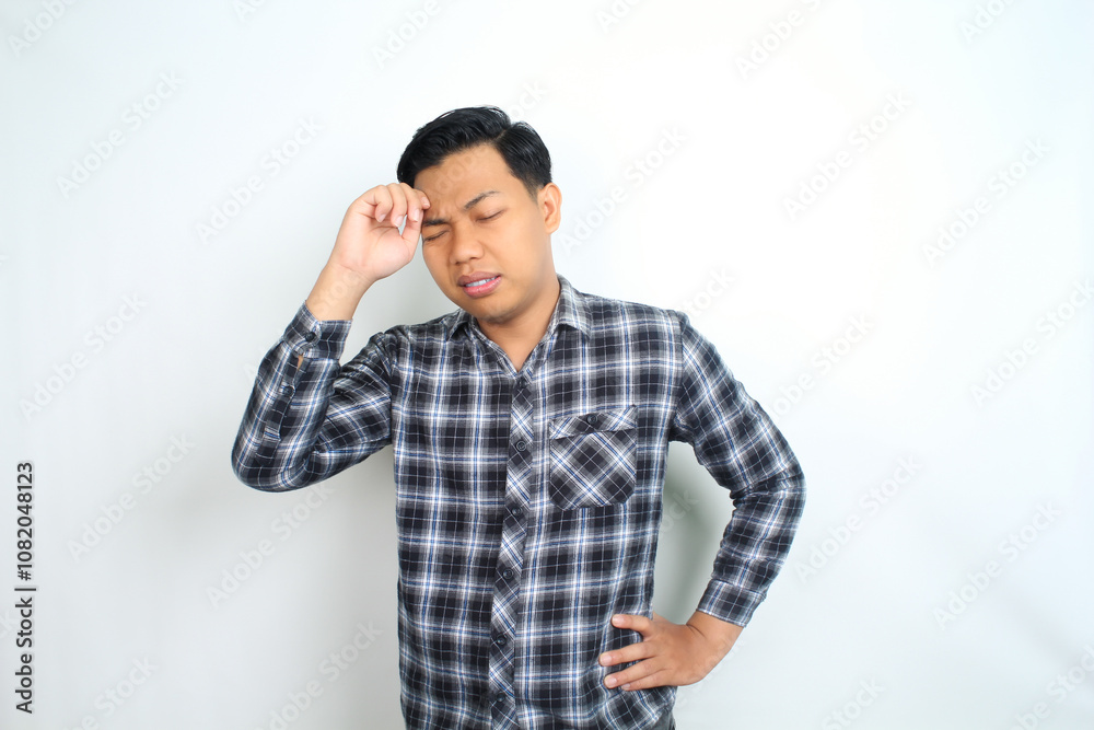 unhealthy asian man feel migraine and fatigue isolated on white wearing casual shirt unhealthy asian man feel migraine and fatigue isolated on white wearing casual shirt