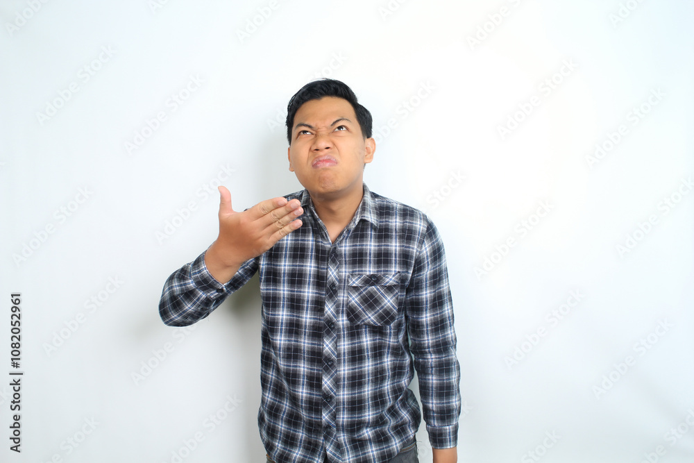 thoughtful asian man smelling stink aroma showing confused expression isolated on white background thoughtful asian man smelling stink aroma showing confused expression isolated on white background