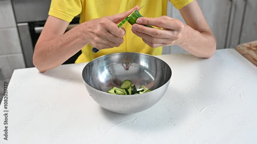 woman's hand cutting cucumber vegetable with knife on cutting board. Cooking Vegetarian food in home kitchen woman's hand cutting cucumber vegetable with knife on cutting board. Cooking Vegetarian food in home kitchen