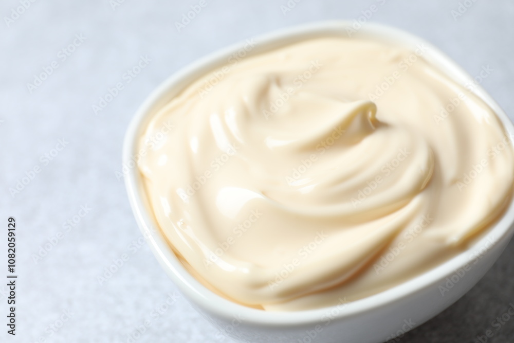Bowl with mayonnaise and ingredients for cooking on the table 