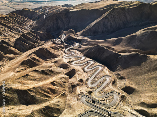 Scenic view of the winding hill road named Pan Long Ancient Road in Tashkurgan, Xinjiang, China. photo