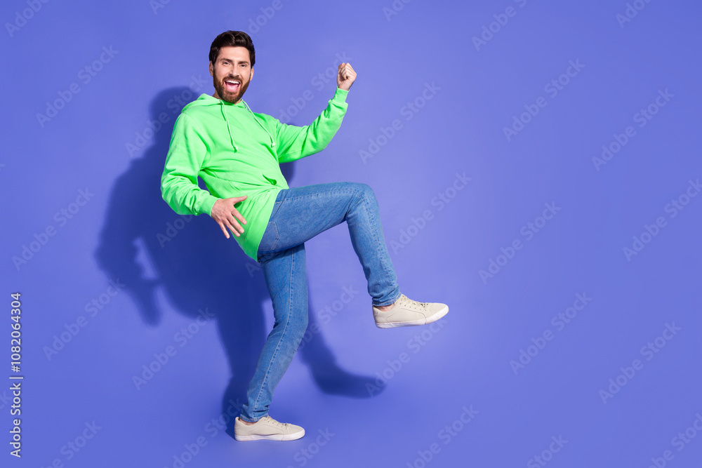 Fototapeta premium Full size photo of pretty young male winning raise fists celebrate wear trendy green outfit isolated on purple color background