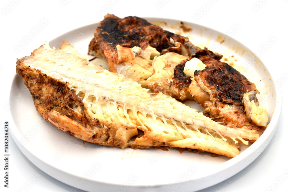 Fried perch fish lies on a clay plate. Fried perch fish lies on a clay plate.