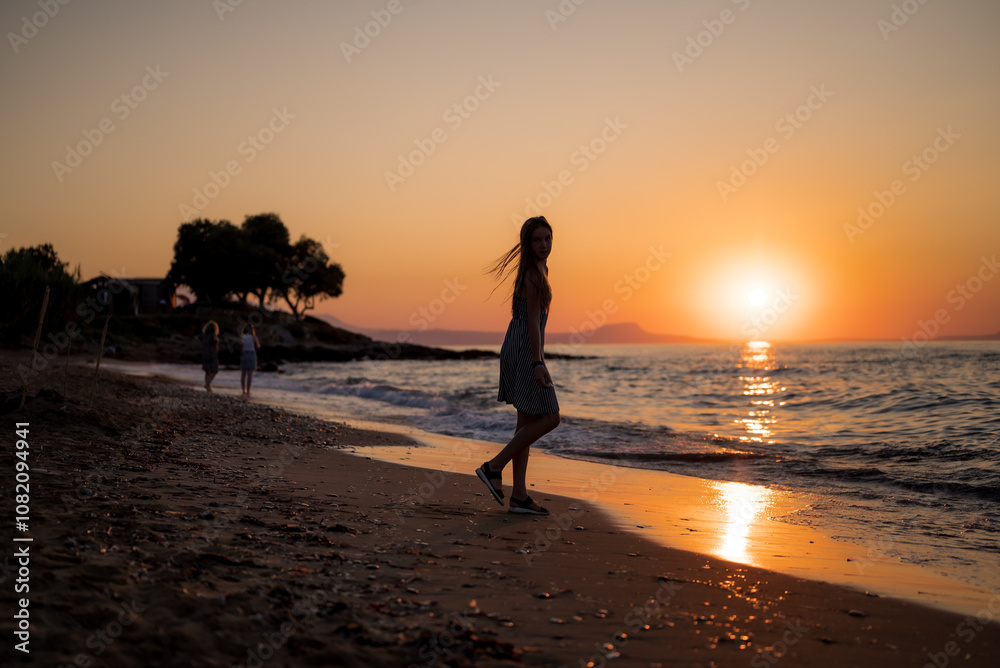 Fototapeta premium a person walking on the beach