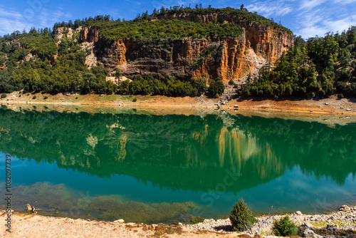 The beautiful crystal clear Aguelmame Sidi Ali Lake. Khenifra National Park, Middle Atlas Mountains, Morocco photo