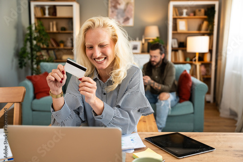 Young businesswoman using credit card and laptop to order and buy new digital tablet that got broken screen. Business female e-commerce online shopping for new device that got damaged.