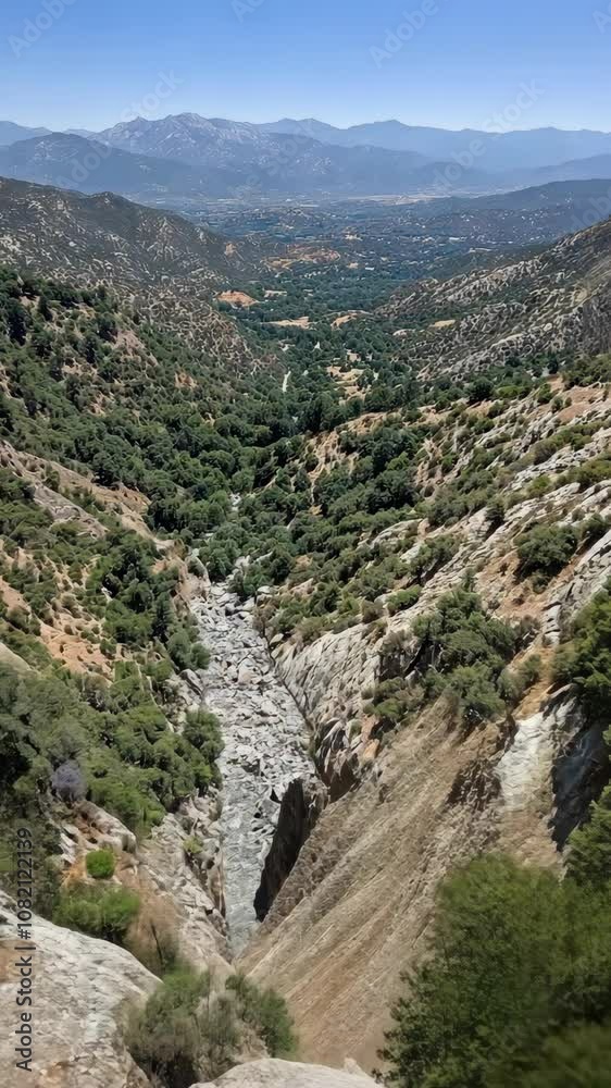 A view of a dry creek bed in the mountains on a clear day A view of a dry creek bed in the mountains on a clear day