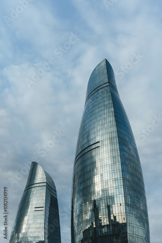 View of baku city bay with flame towers modern architecture on top of hill in blue sky