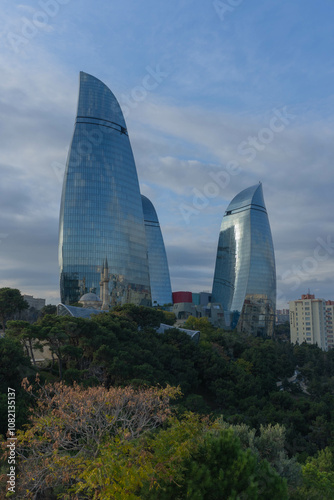 View of baku city bay with flame towers modern architecture on top of hill in blue sky