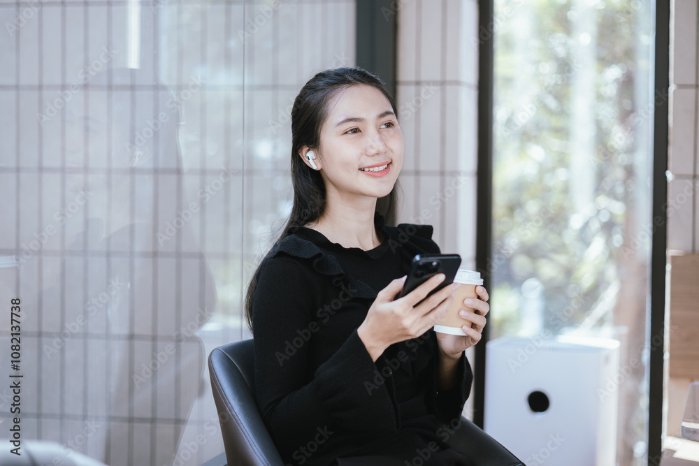 Happy Asian woman working on laptop at coffee shop. Student studying online, surfing the internet. Happy Asian woman working on laptop at coffee shop. Student studying online, surfing the internet.