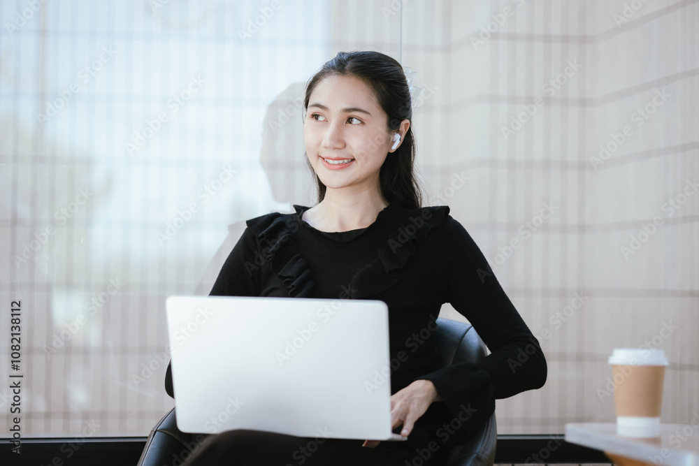Portrait of a businesswoman drinking coffee at her desk with laptop in a coffee shop. Portrait of a businesswoman drinking coffee at her desk with laptop in a coffee shop.