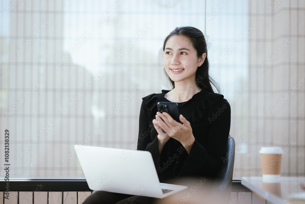 Portrait of a businesswoman drinking coffee at her desk with laptop in a coffee shop. Portrait of a businesswoman drinking coffee at her desk with laptop in a coffee shop.