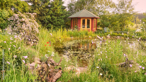 garden with red garden house in an ecologically desirable way
