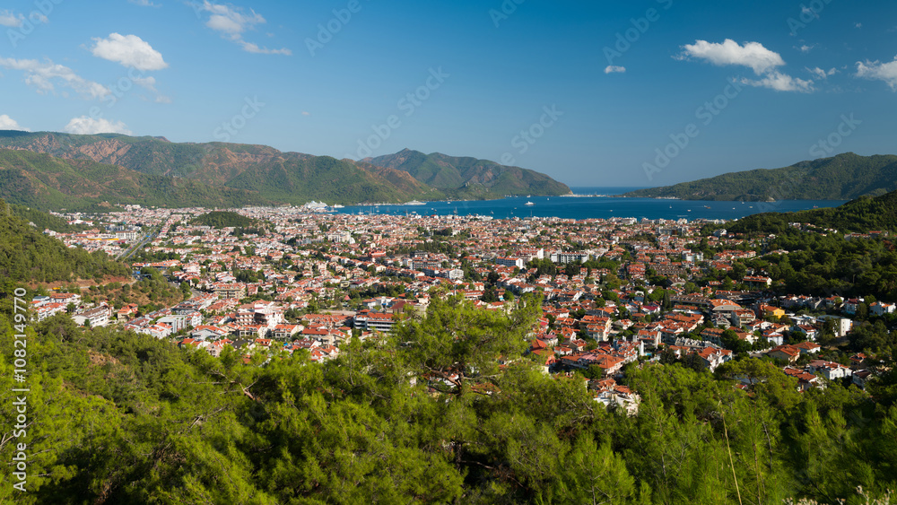 Top view of Marmaris town. Colourful view of the Turkish city in the middle of the day. Beautiful sky in the summer season. Mediterranean coast. Mugla province, Turkey Top view of Marmaris town. Colourful view of the Turkish city in the middle of the day. Beautiful sky in the summer season. Mediterranean coast. Mugla province, Turkey