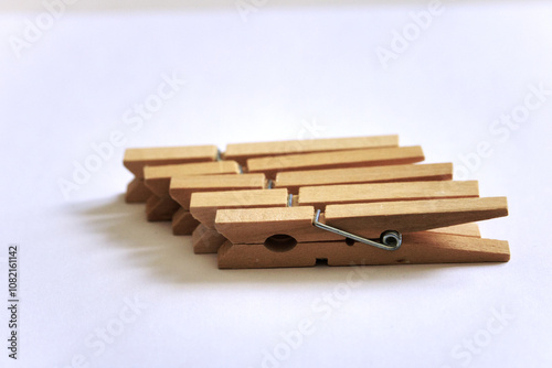 five clothespins wood closeup white background