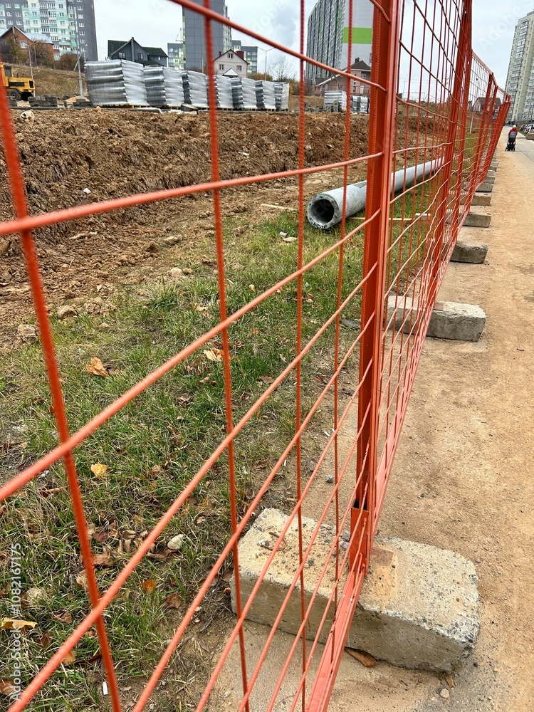 Fototapeta premium construction, building materials stacked behind the fence 