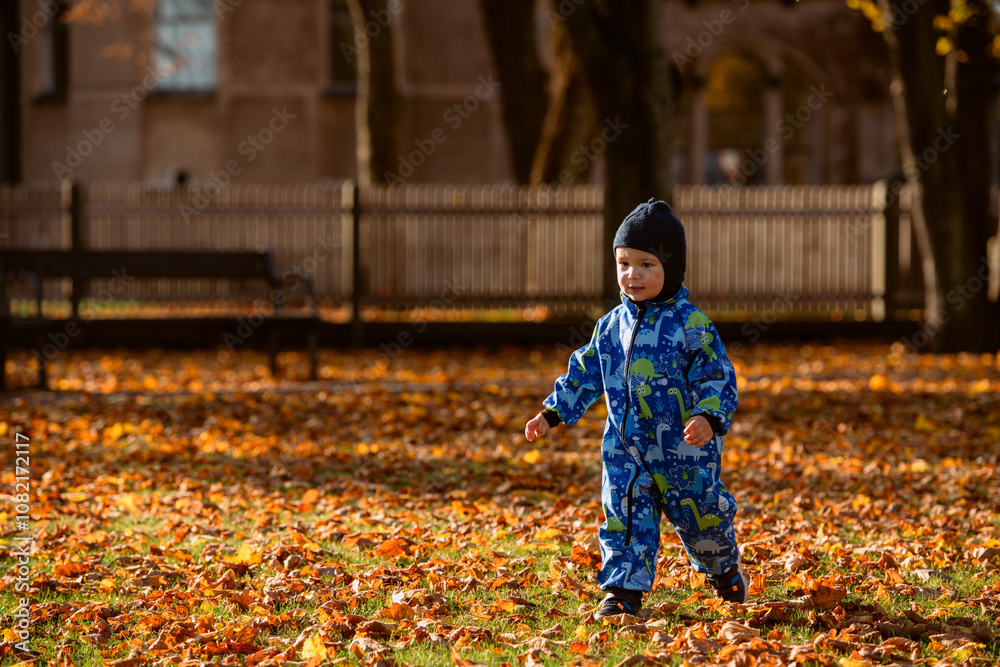 A joyful little boy in his winter coat and hat plays happily in the park, surrounded by the love and warmth of his smiling parents A joyful little boy in his winter coat and hat plays happily in the park, surrounded by the love and warmth of his smiling parents