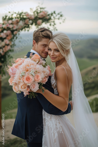 A couple stands together, enjoying their wedding day in a scenic outdoor venue