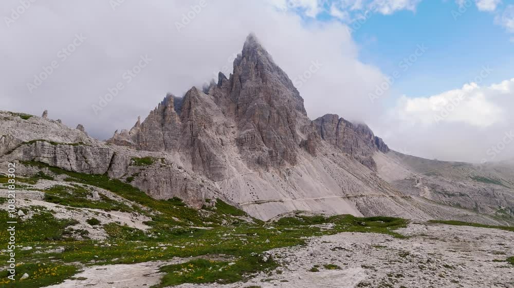 Epic aerial orbit of Dolomite Alps, panning left with clouds over peaks near sunset in 4K Epic aerial orbit of Dolomite Alps, panning left with clouds over peaks near sunset in 4K