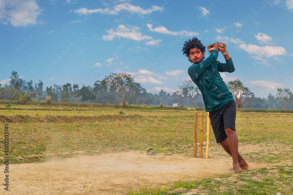 Rural boy playing cricket in village located in West bengal, India Rural boy playing cricket in village located in West bengal, India