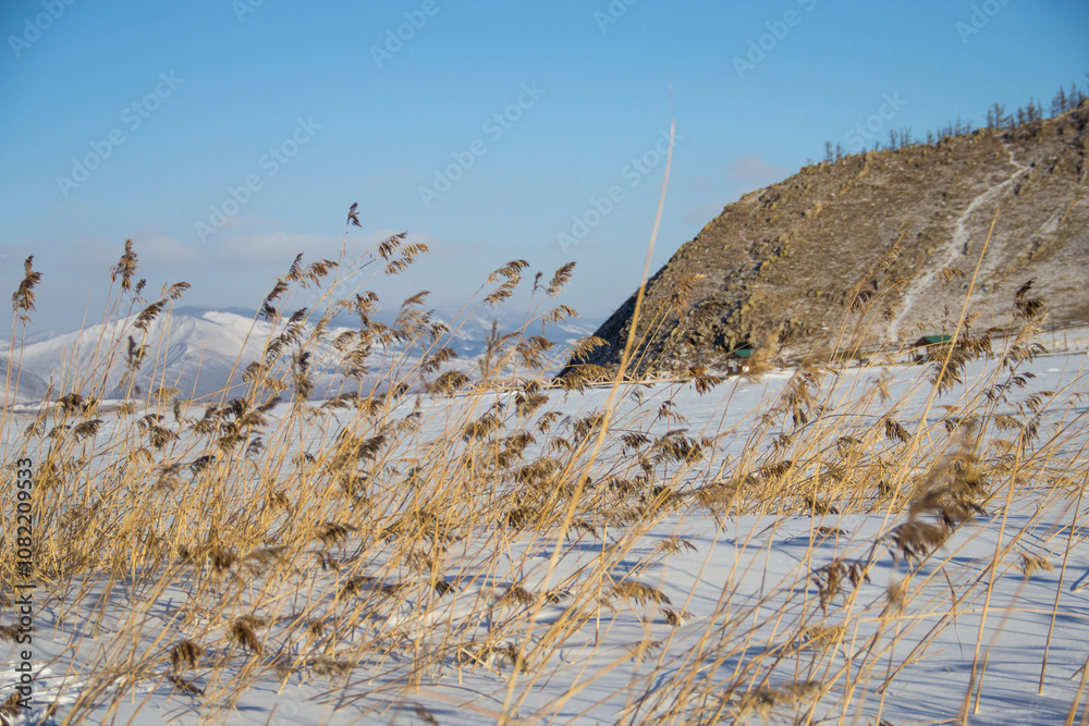 Obraz premium Winter landscape, beautiful view of the frozen lake and the mountains around it Lake Baikal in Russia