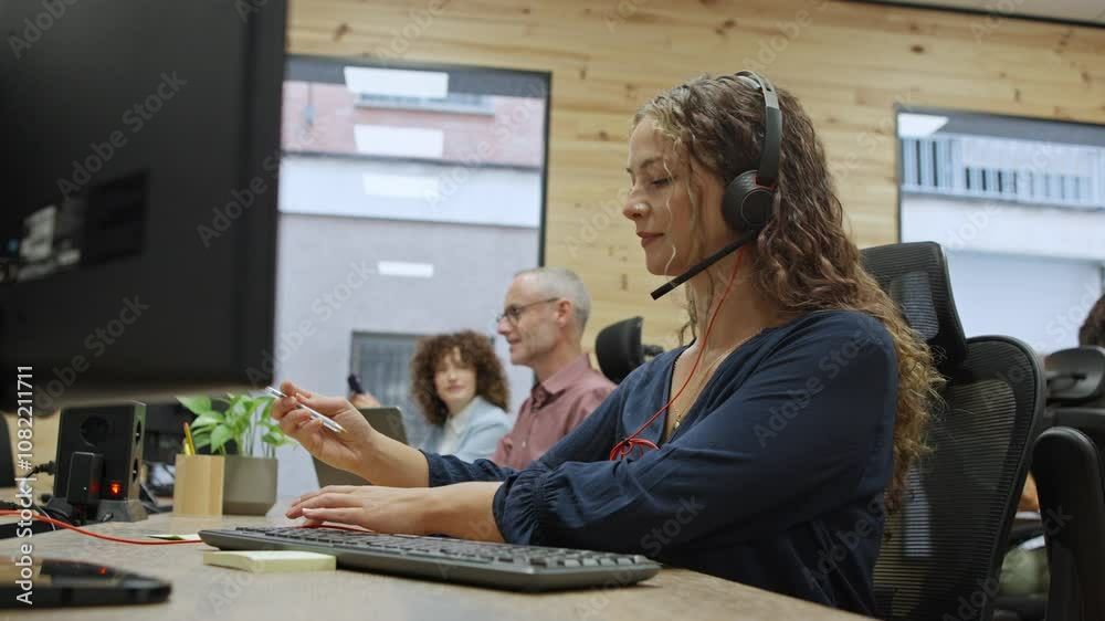 Customer service representative working at her desk - business concept Customer service representative working at her desk - business concept