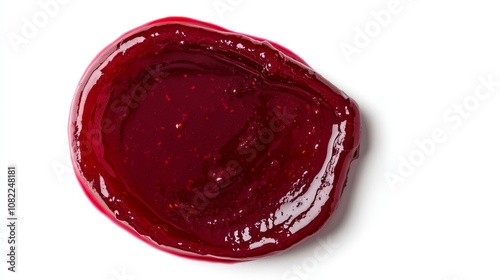 An abstract smear of sweet, scarlet berry jam or sauce isolated on a white backdrop with a clipping path, observed from above.