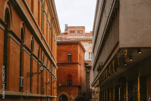 Bologna cityscape featuring narrow street with traditional buildings and modern architecture, showcasing the blend of old and new in emilia romagna, italy