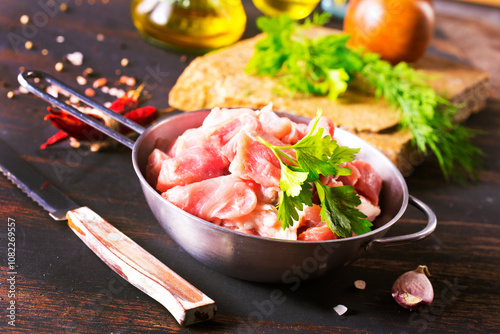 raw meat in metal bowl, meat and herb and spices photo