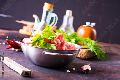 raw meat in metal bowl, meat and herb and spices photo