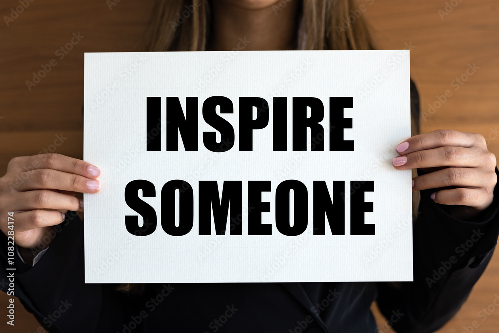 Inspire someone. Woman with white page, black letters. Advice, encouragement, inspiration, motivation. Inspire someone. Woman with white page, black letters. Advice, encouragement, inspiration, motivation.